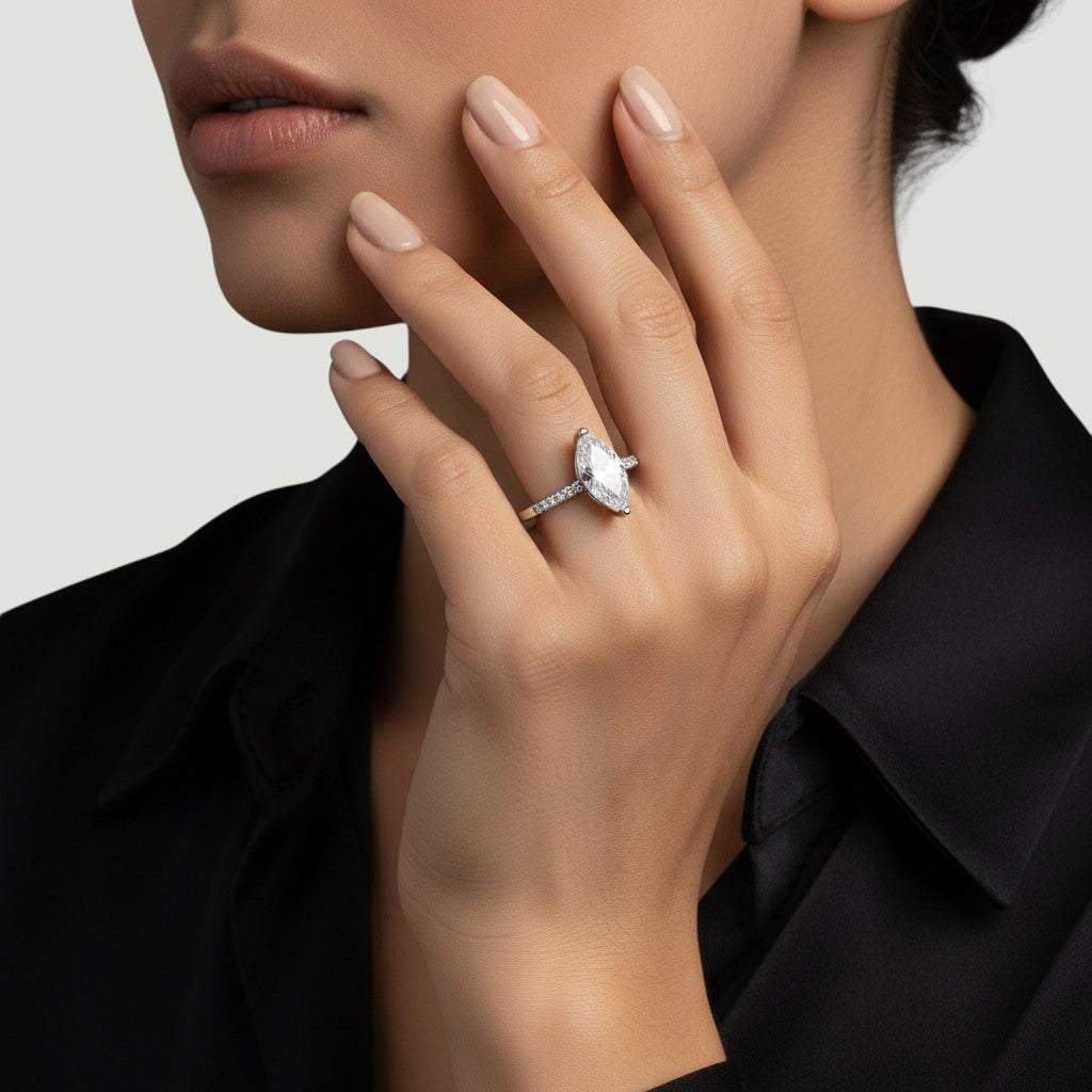 NAGPAL JEWELLERS The Grace Solitaire ring with a marquise-cut diamond and pave set diamonds on a white gold band.