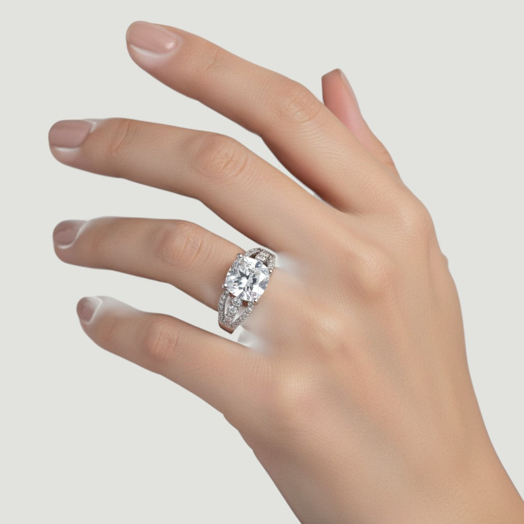 NAGPAL JEWELLERS The Infinity Knot ring with a large cushion-cut diamond and pave set stones on the band.