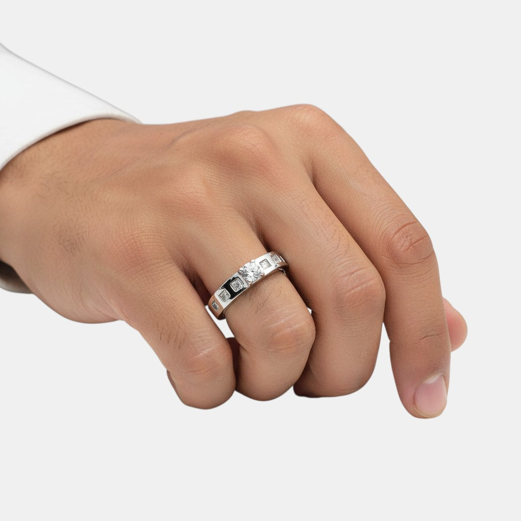 NAGPAL JEWELLERS The Lumina Sequence Band, a white gold ring with a central round diamond and channel-set smaller diamonds.