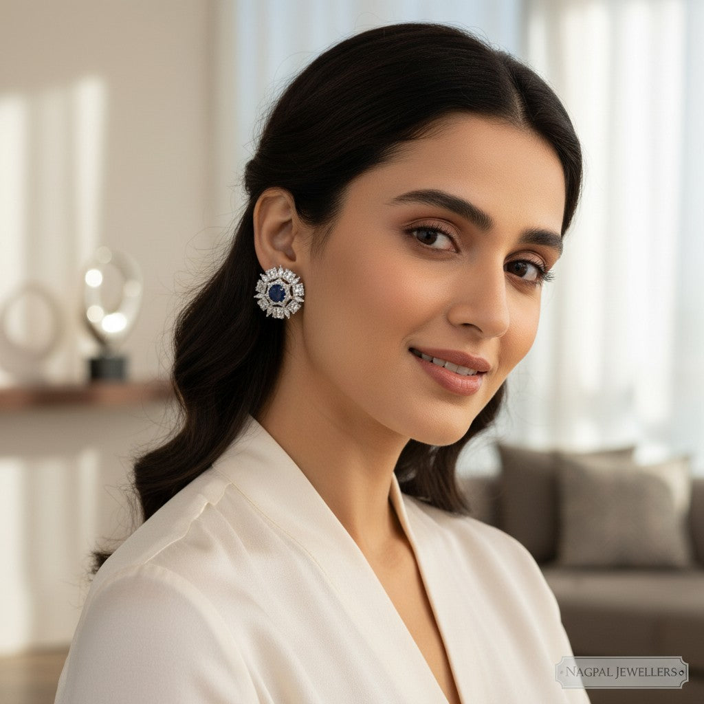 NAGPAL JEWELLERS Midnight Radiance Discs, 92.5 silver earrings with deep blue central stone and surrounding clear crystals.