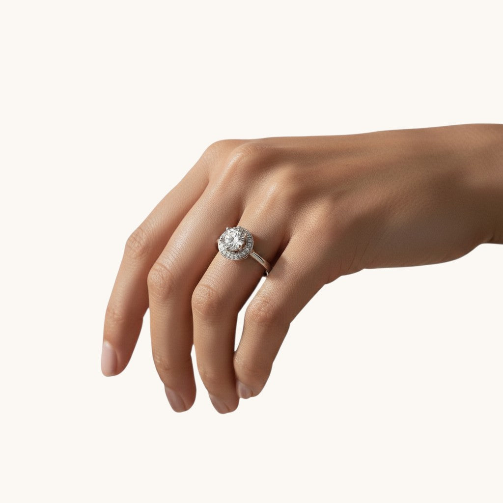NAGPAL JEWELLERS The Orbit Rise ring, size 12, featuring a central round-cut diamond surrounded by a halo of smaller diamonds on a white gold band.