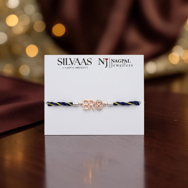 SILVAAS premium silver BRO-8 Rakhi featuring a rose gold letter charm on a navy blue and gold braided thread
