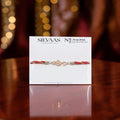 SILVAAS premium silver #Bro Rakhi featuring a sparkling hashtag charm on a maroon and gold thread display card