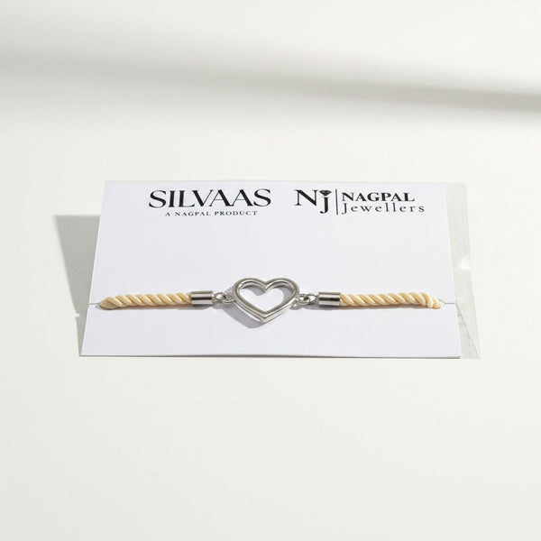 SILVAAS silver heart charm bracelet with cream twisted rope cord on a branded display card