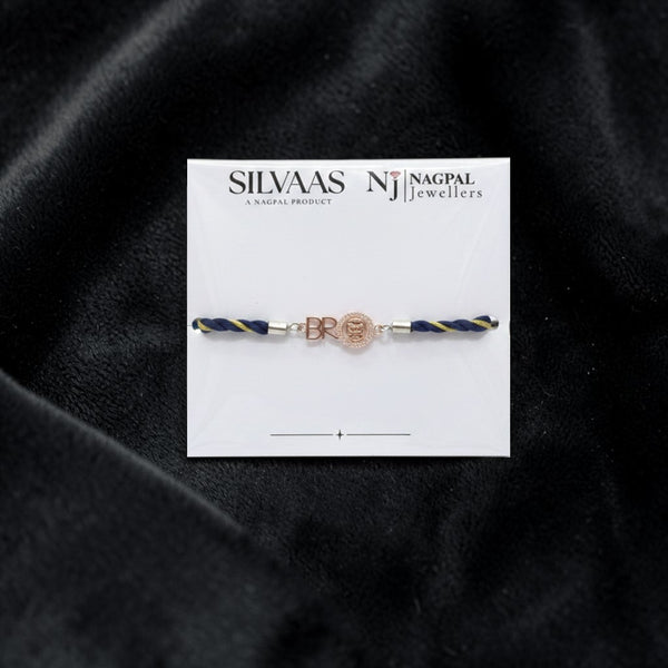 SILVAAS premium silver BRO Jaguar car logo rakhi with blue and gold braided thread on a white display card.