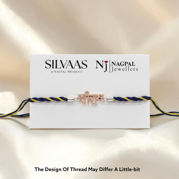 SILVAAS premium silver Veera Rakhi featuring a delicate metallic centerpiece on a blue and gold braided thread