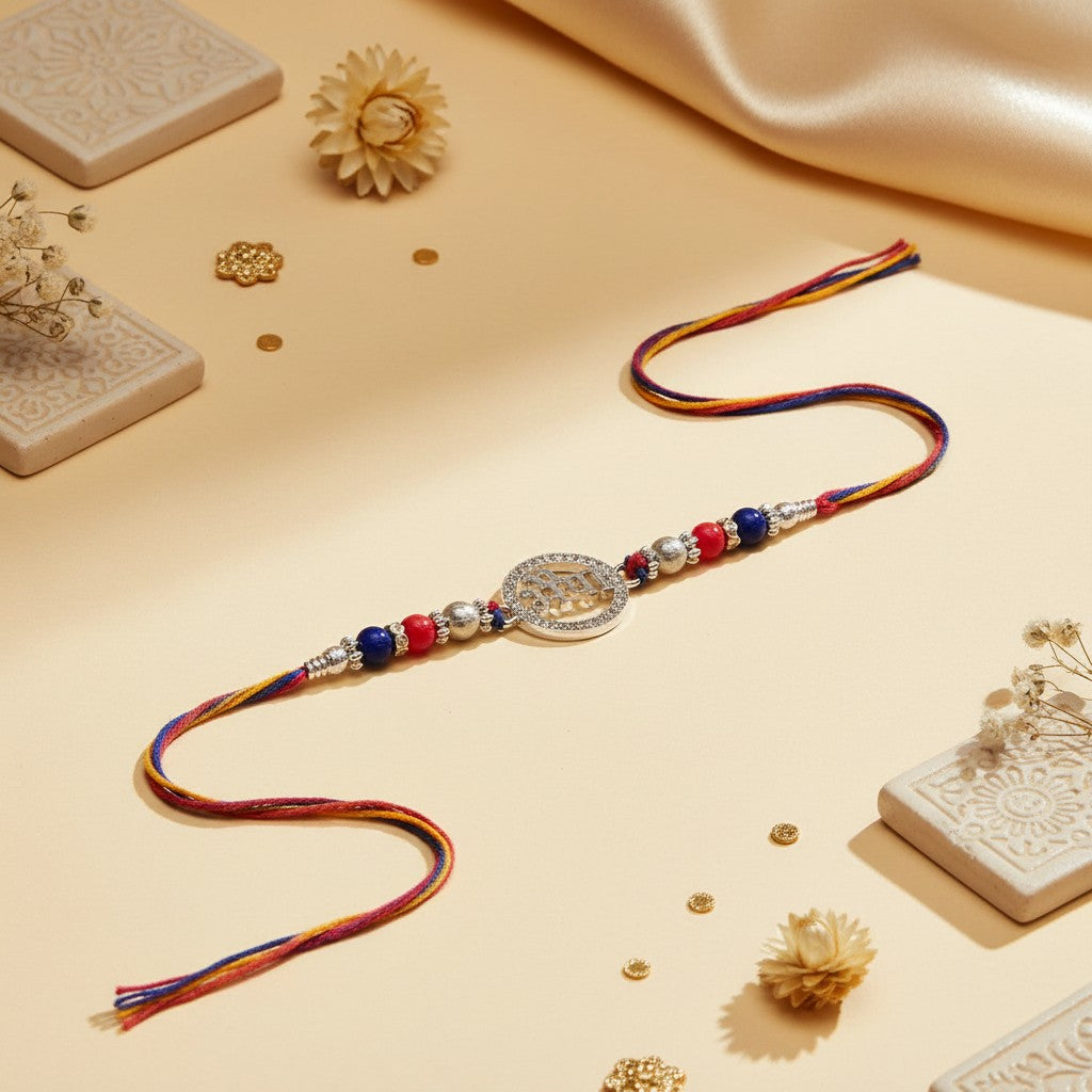 SILVAS decorative Rakhi bracelet with a central silver-toned circular charm, red and blue beads, and colorful threads.