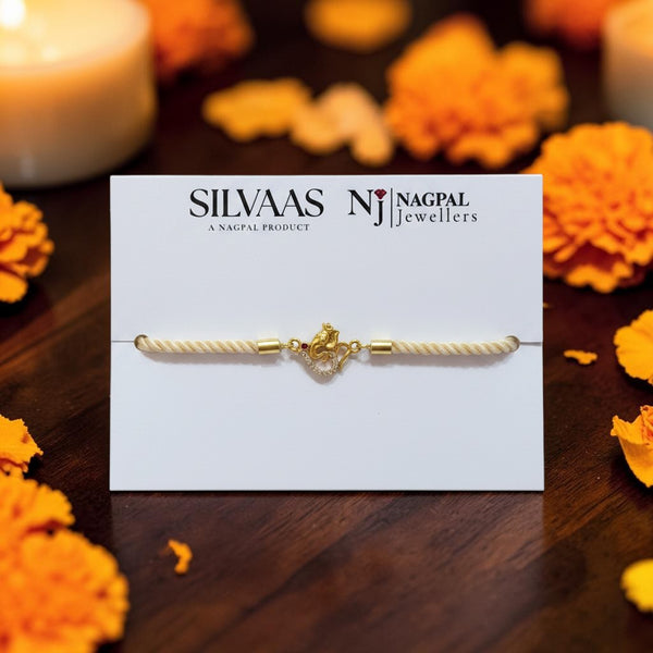 SILVAS premium silver Hanuman Ji Rakhi with gold-tone finish and stone accents on a white display card