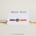SILVAS Khanda symbol rakhi bracelet with a silver charm and multicolored braided thread on a display card