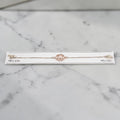 SILVAS rose gold tone sterling silver bracelet featuring a circular trident charm with delicate stone accents
