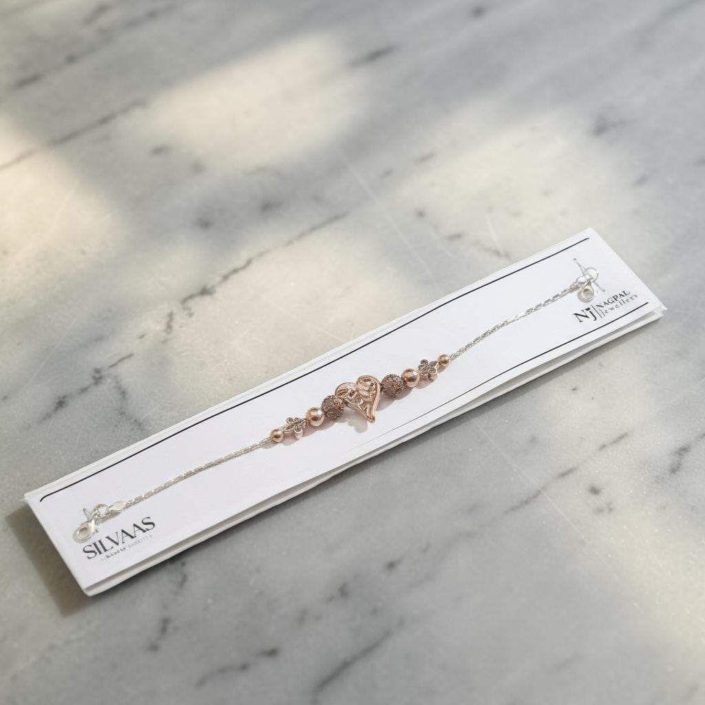 SILVAS 92.5 sterling silver bracelet featuring a rose gold heart charm and decorative beads on a display card