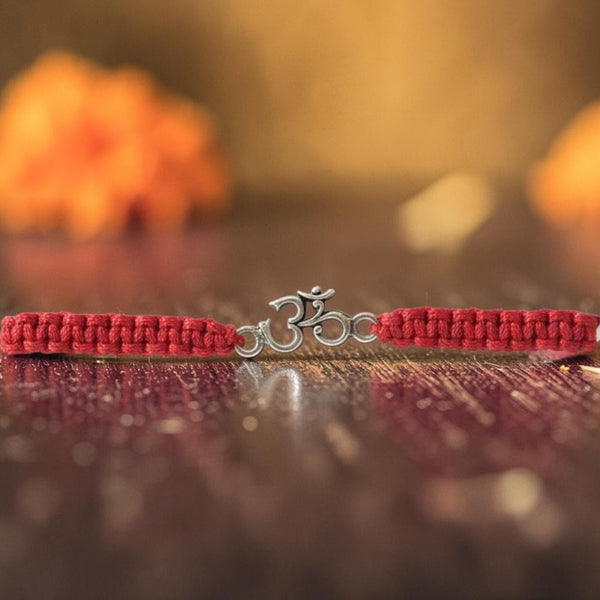 SILVAS sterling silver Om symbol rakhi on a braided red thread for children