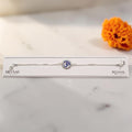 SILVAS 92.5 sterling silver Rakhi featuring a circular blue OM symbol charm on a delicate box chain