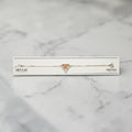 SILVAS 92.5 sterling silver bracelet featuring a diamond-encrusted triangle charm with orange Super Bro text